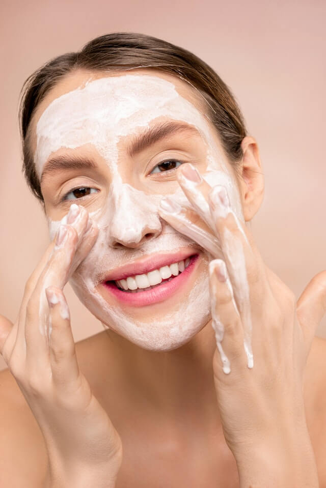 Cleansing Your Skin - Woman cleanses her skin